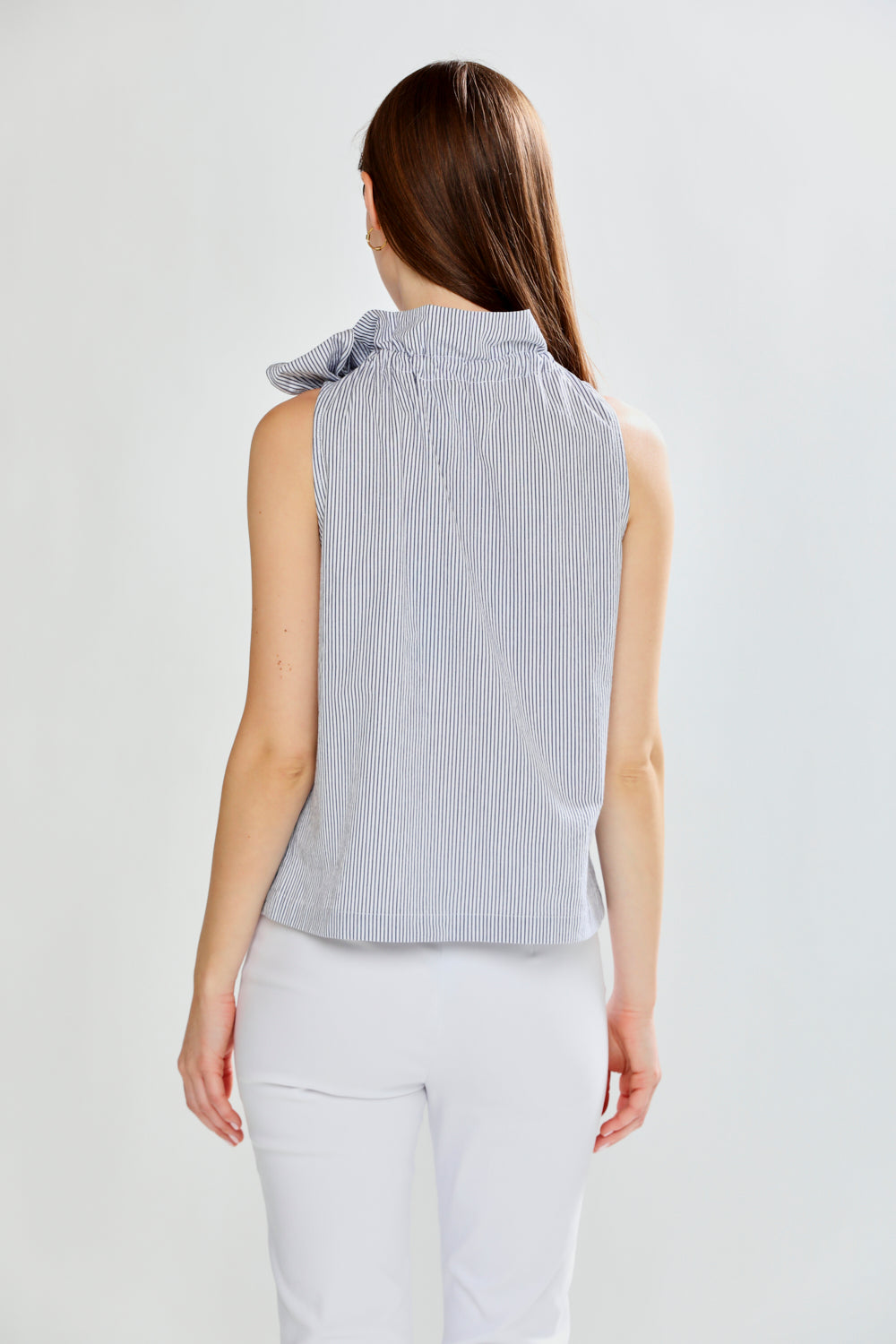 Woman wearing SLEEVELESS TOP W/TIE AT NECK