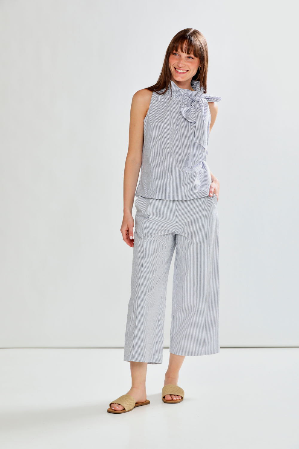 Woman wearing SLEEVELESS TOP W/TIE AT NECK