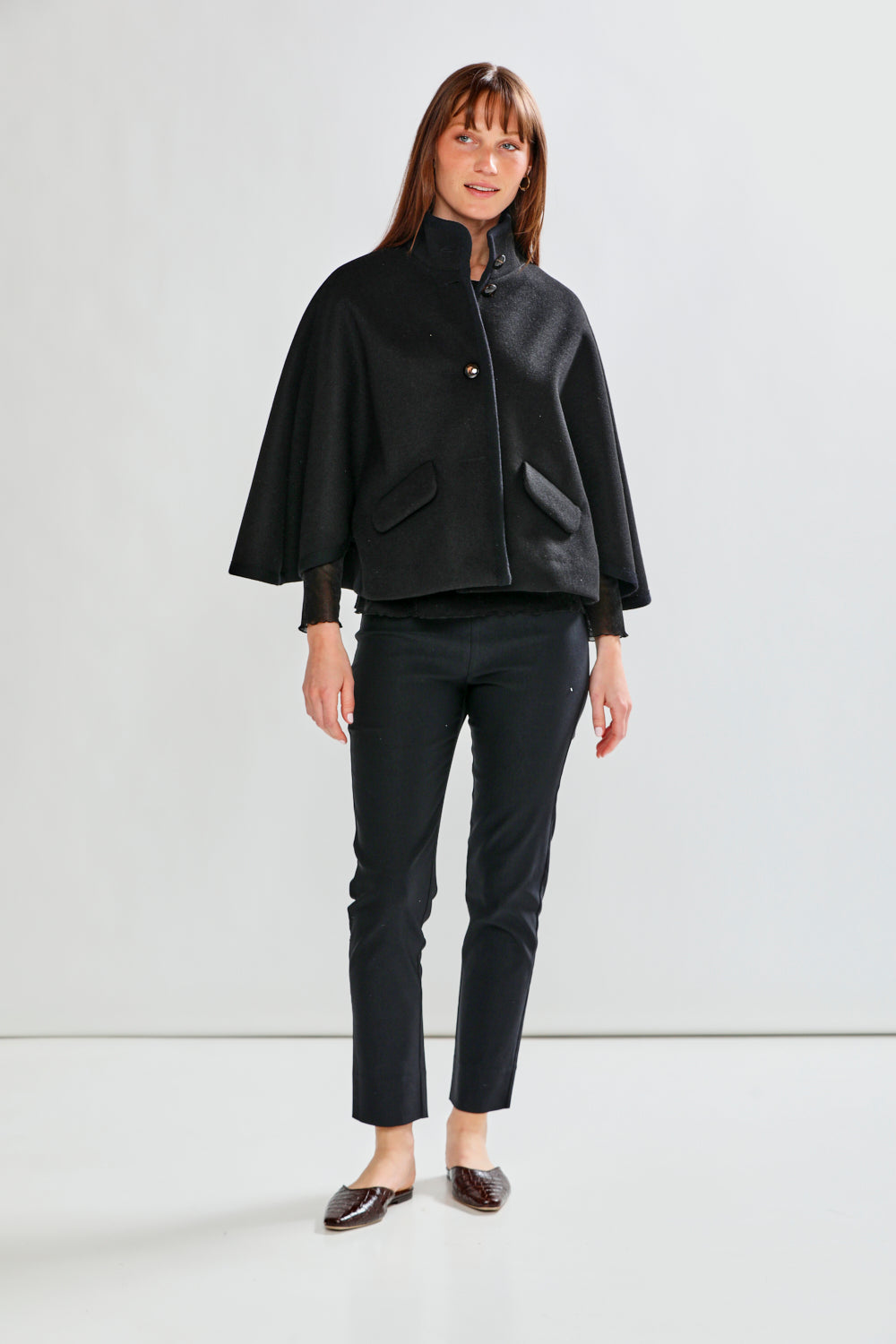 Woman wearing CLAUDIE CAPE - BLACK