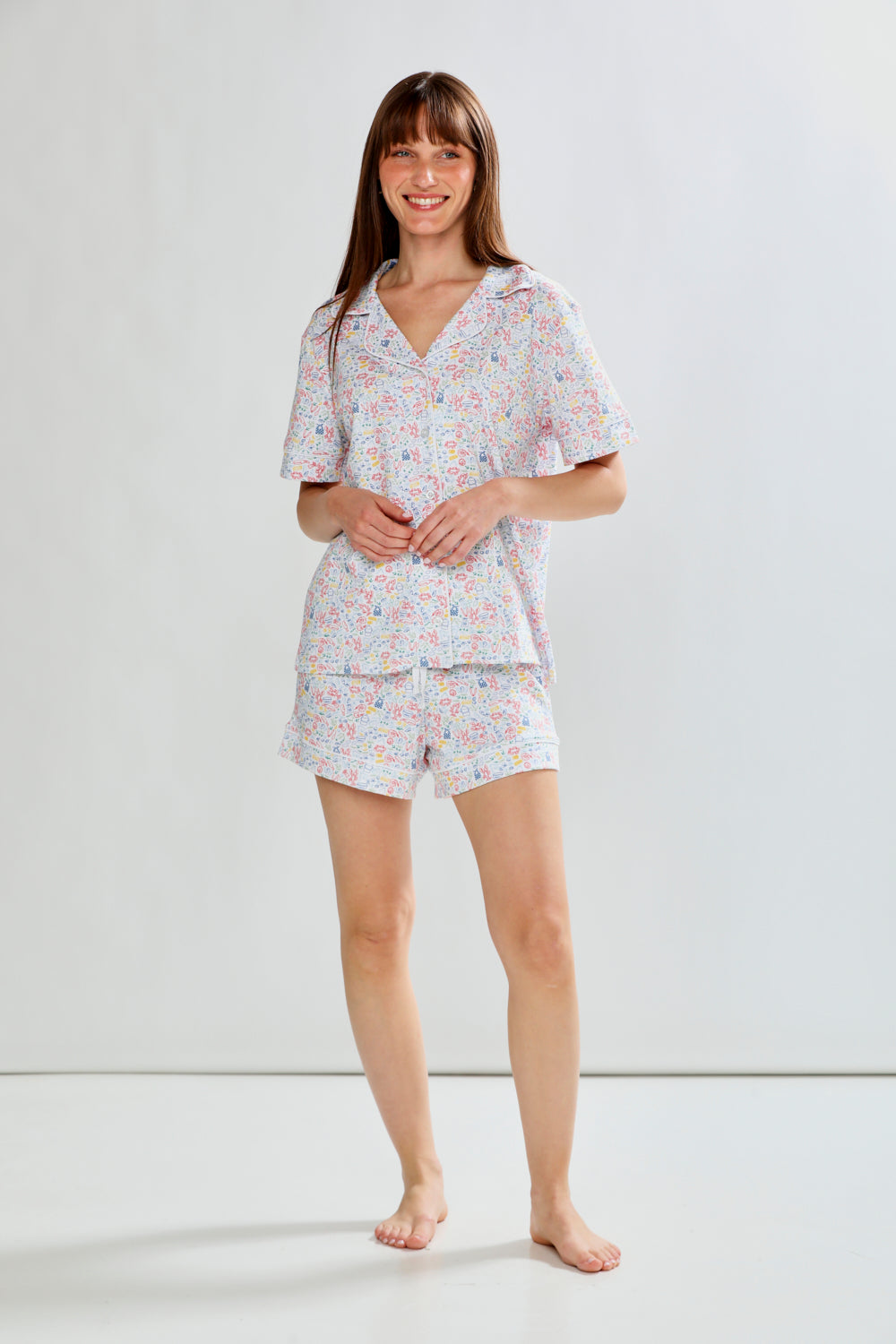 Woman wearing lobster print pajama set on a white background