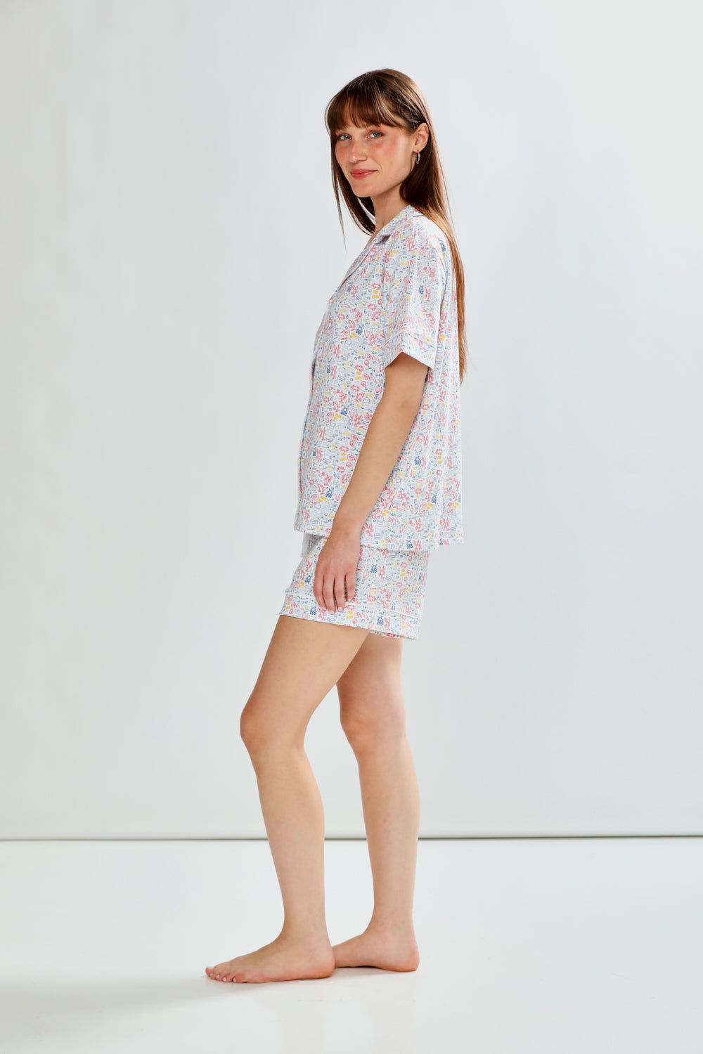 Woman wearing lobster print pajama set on a white background
