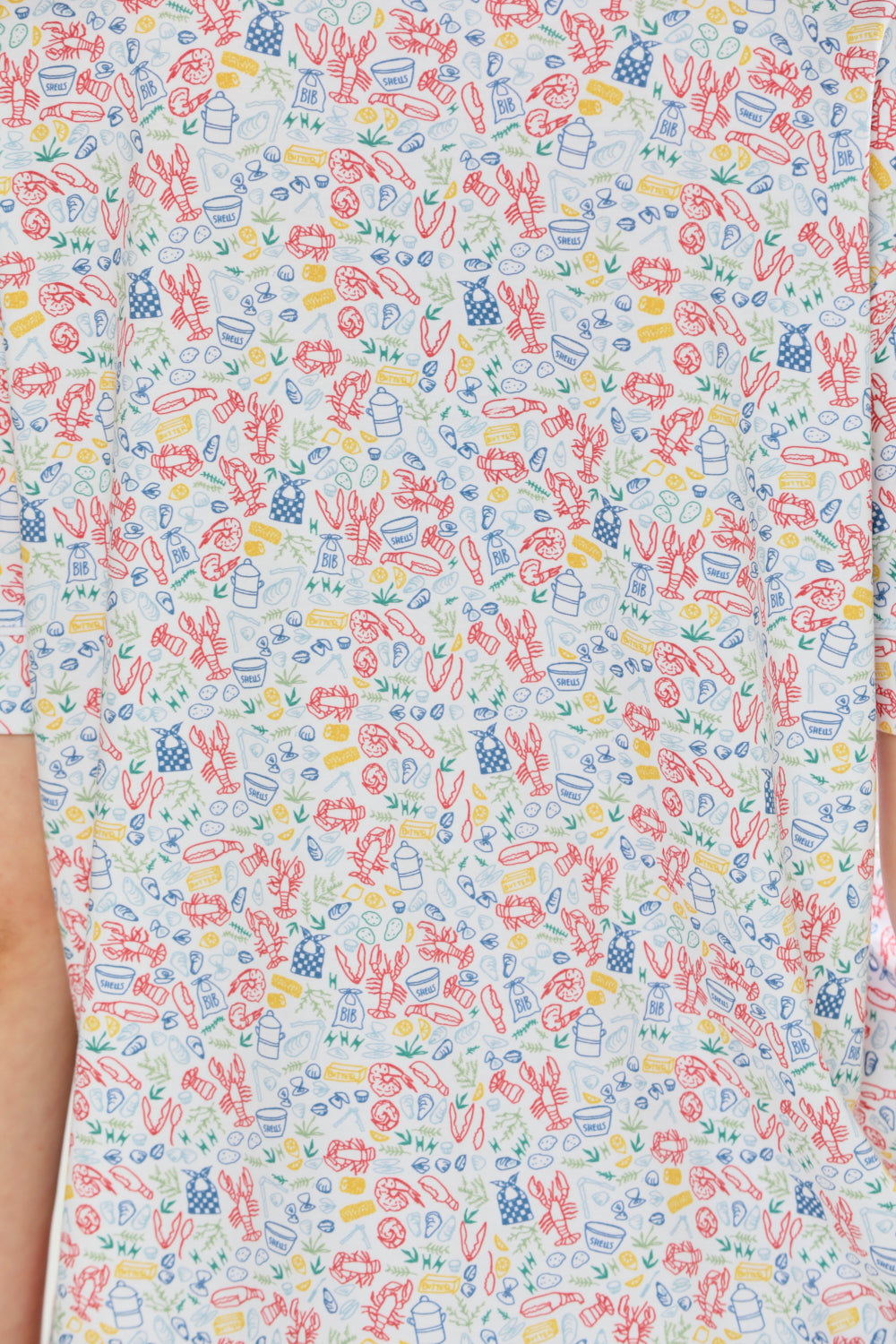 Woman wearing lobster print pajama set on a white background