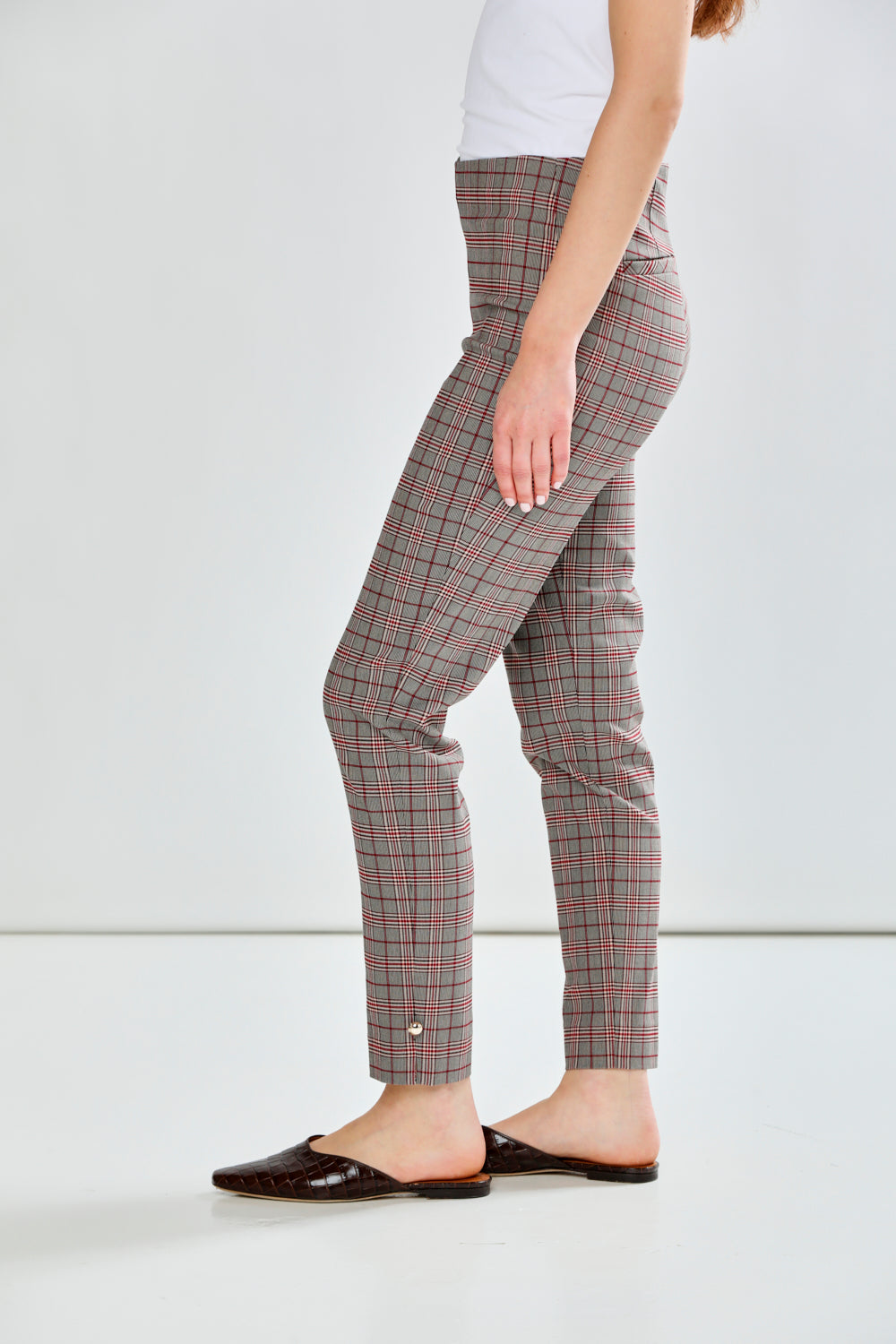 Person wearing plaid pants on a white background