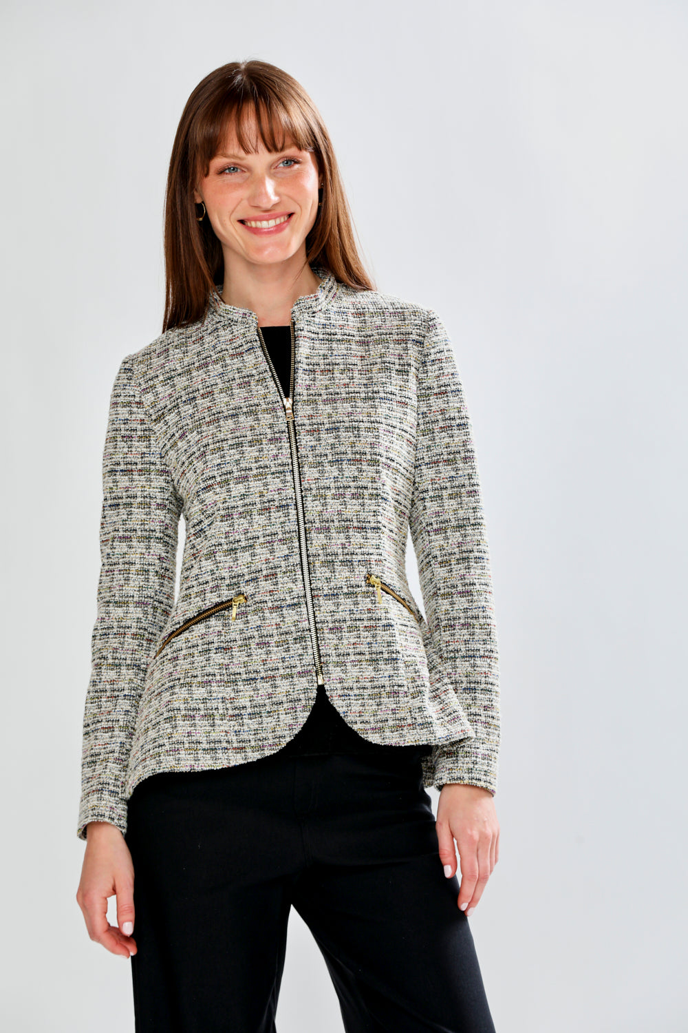 Woman wearing a patterned jacket on a plain background