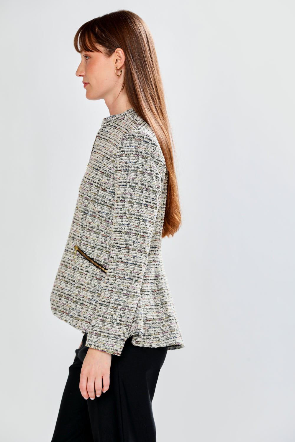 Woman wearing a patterned jacket on a plain background