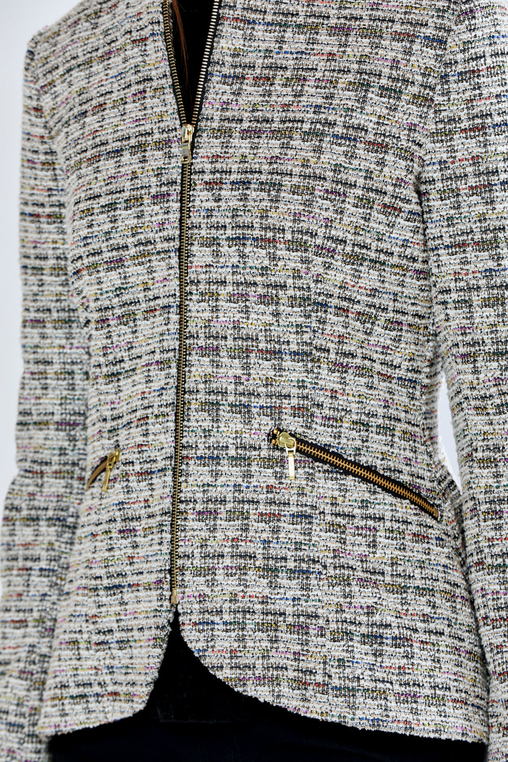 Woman wearing a patterned jacket on a plain background