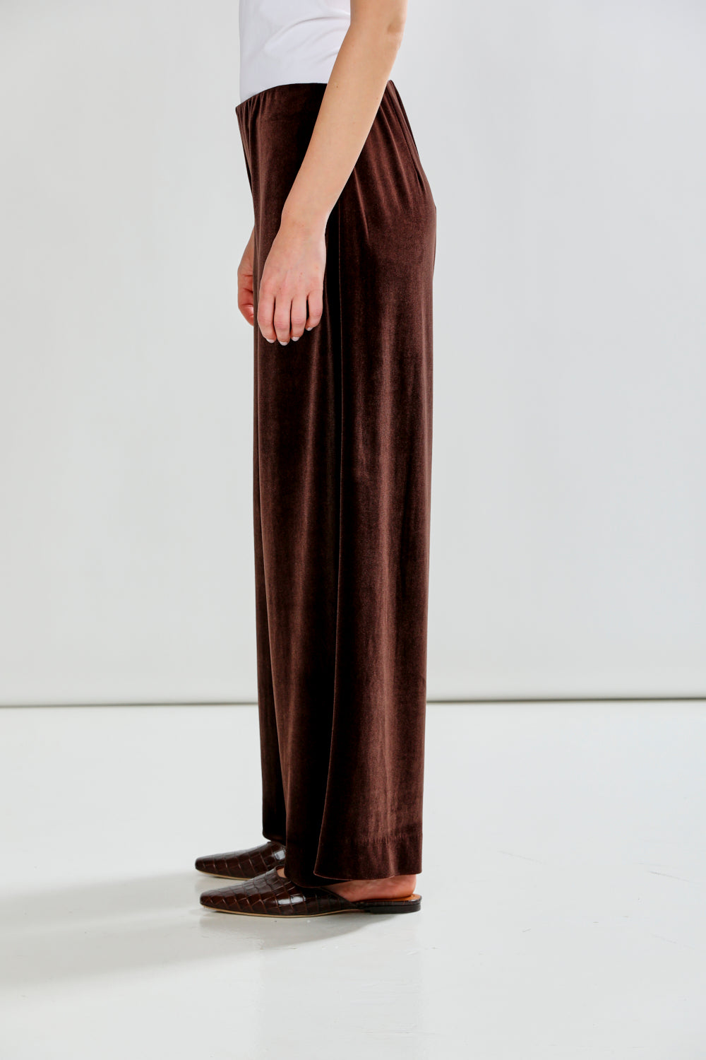 Brown wide-leg pants worn by a person on a white background