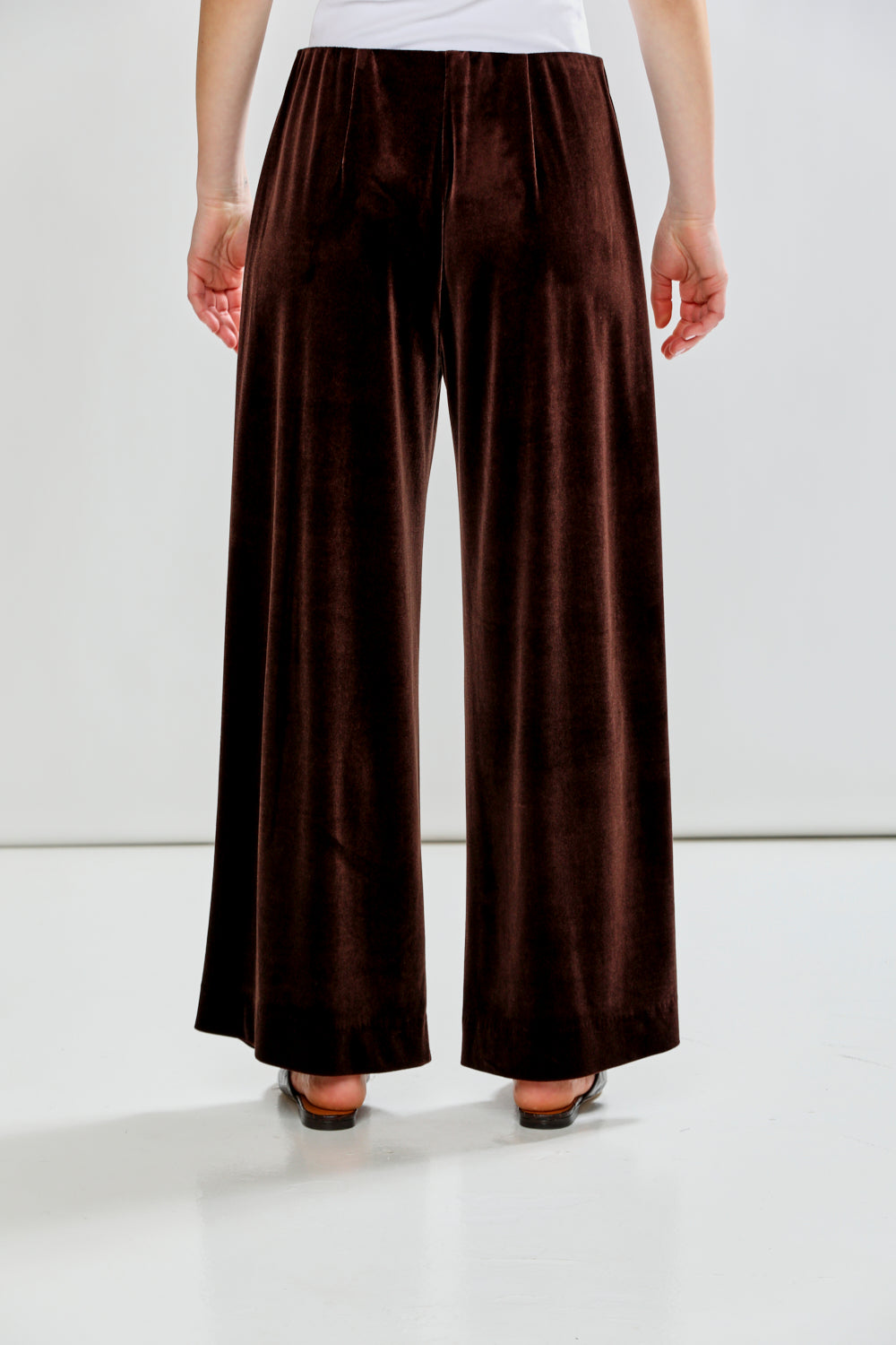 Brown wide-leg pants worn by a person on a white background