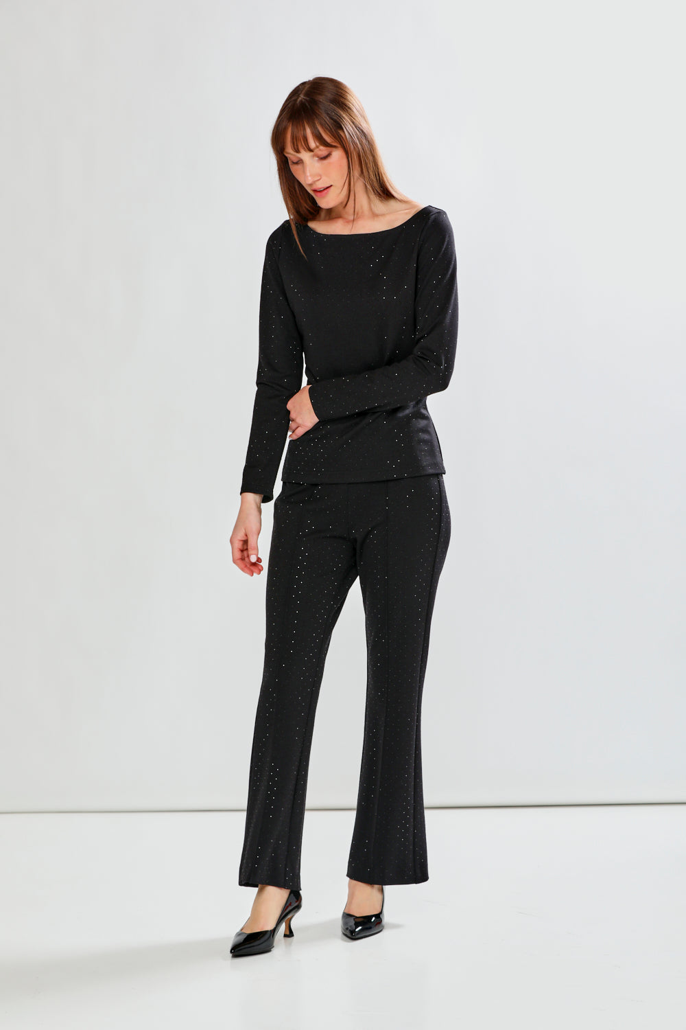 Woman wearing a black outfit with a white background