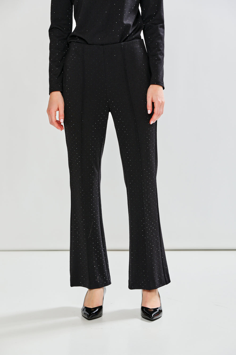 Black textured dress with matching pants on a white background