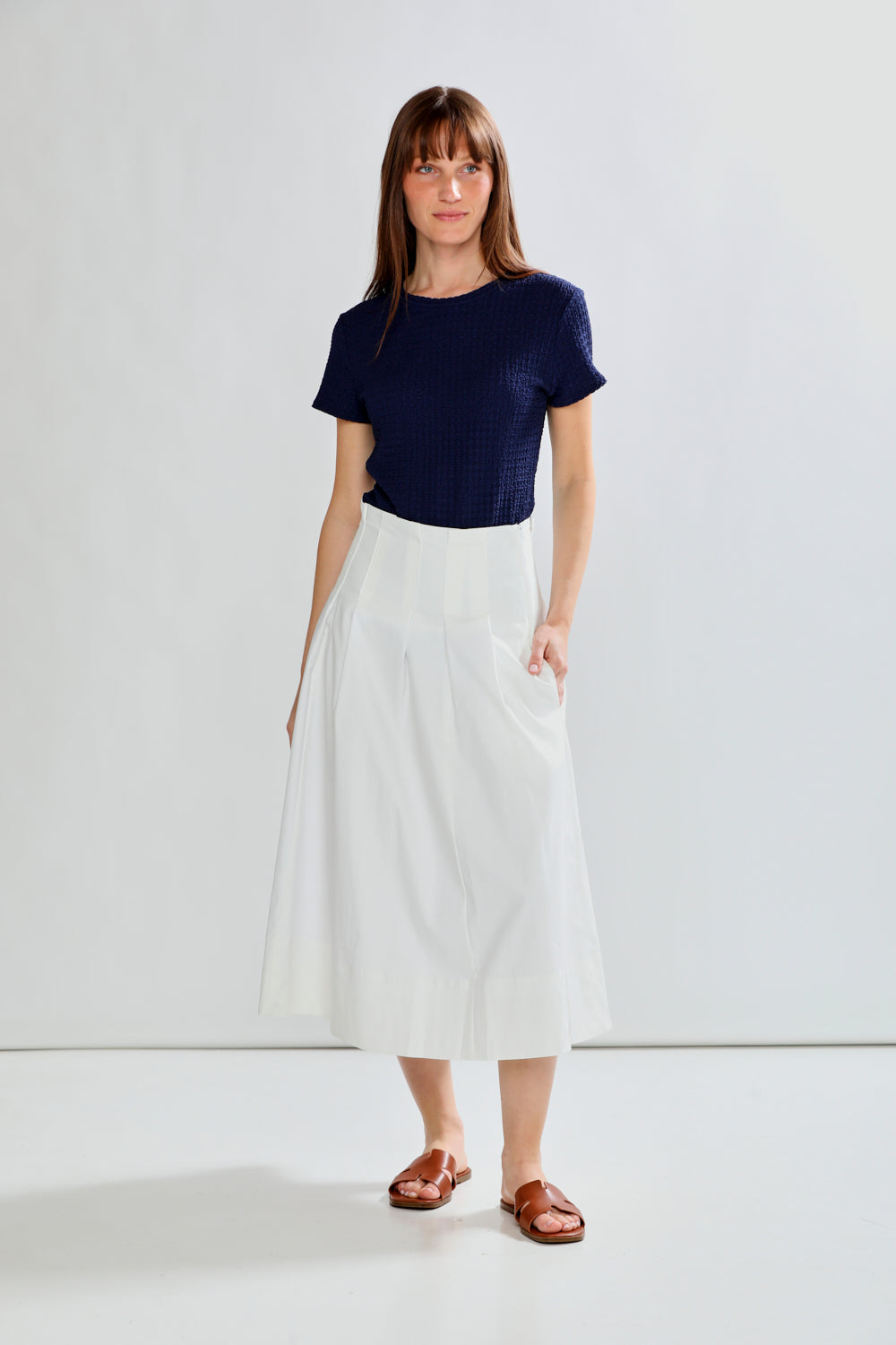 woman in pleated skirt