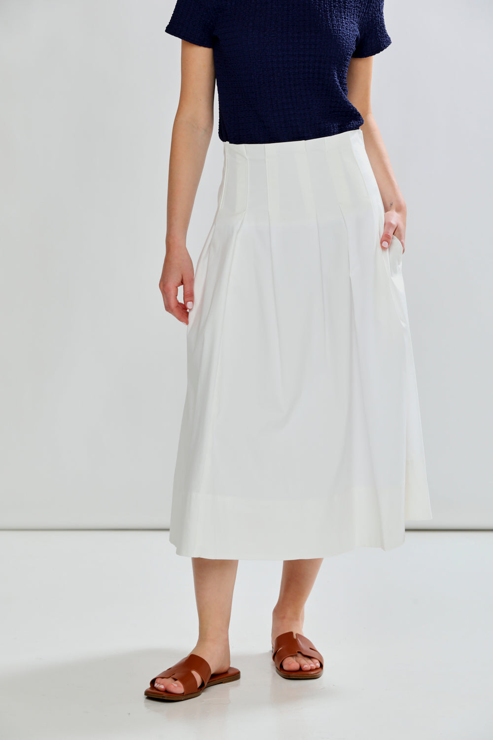 woman in pleated skirt