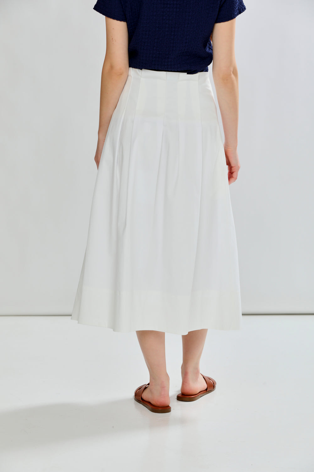 woman in pleated skirt