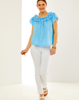 Woman in pacific blue ruffled top