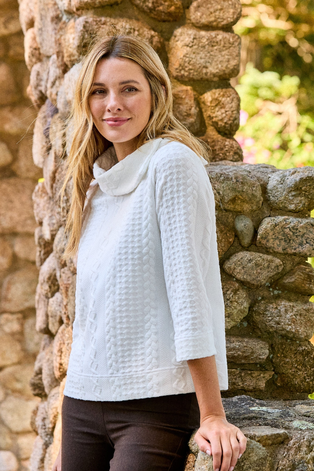 Girl in white sweater and brown pants 