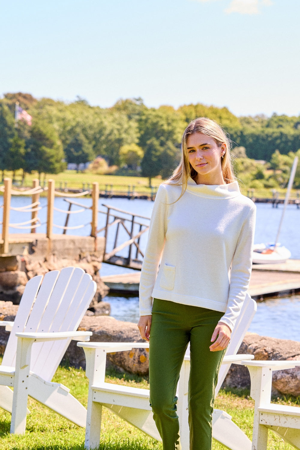 Girl in white sweater and green pants