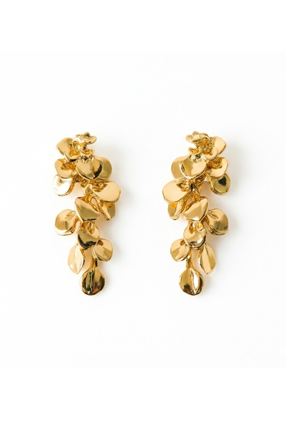 Pair of gold floral earrings on a white background