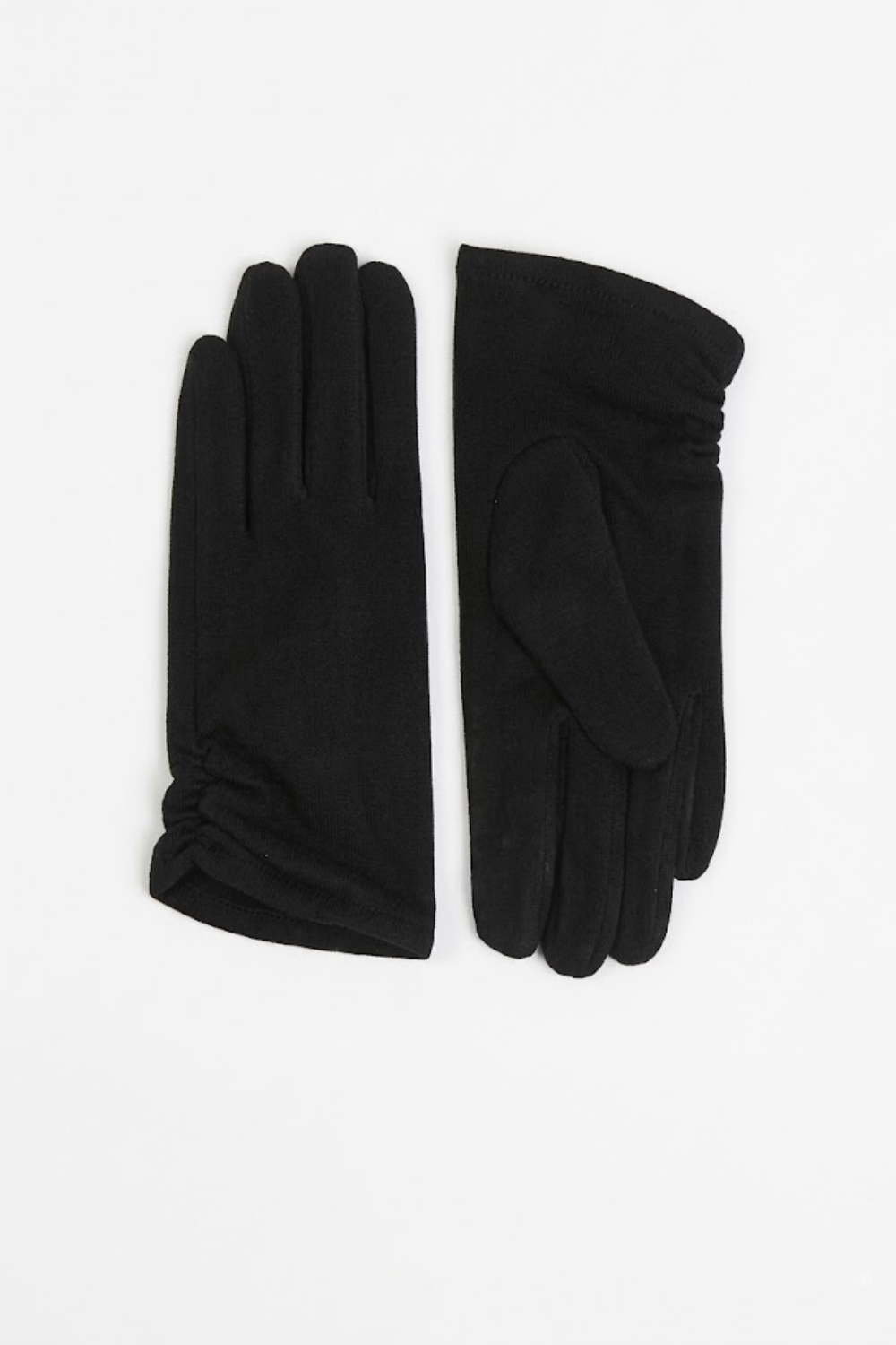 A pair of black knit gloves, one showing the back with long finger seams and the other showing the palm with a thumb loop, laid flat on a white background.