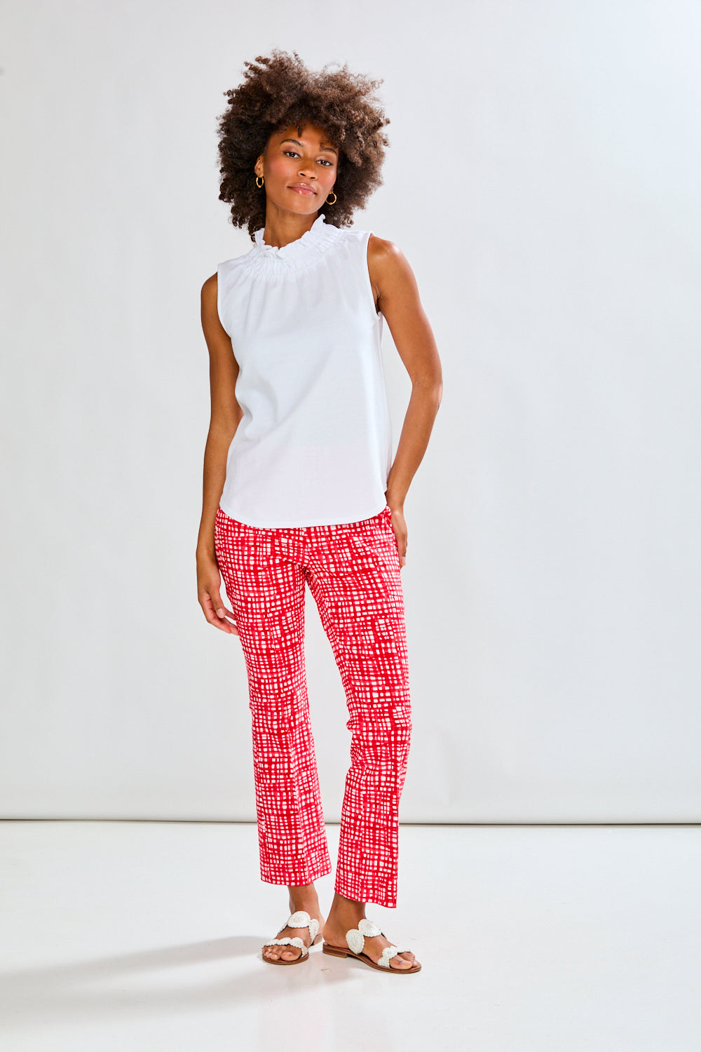 Woman in white top and patterned pants