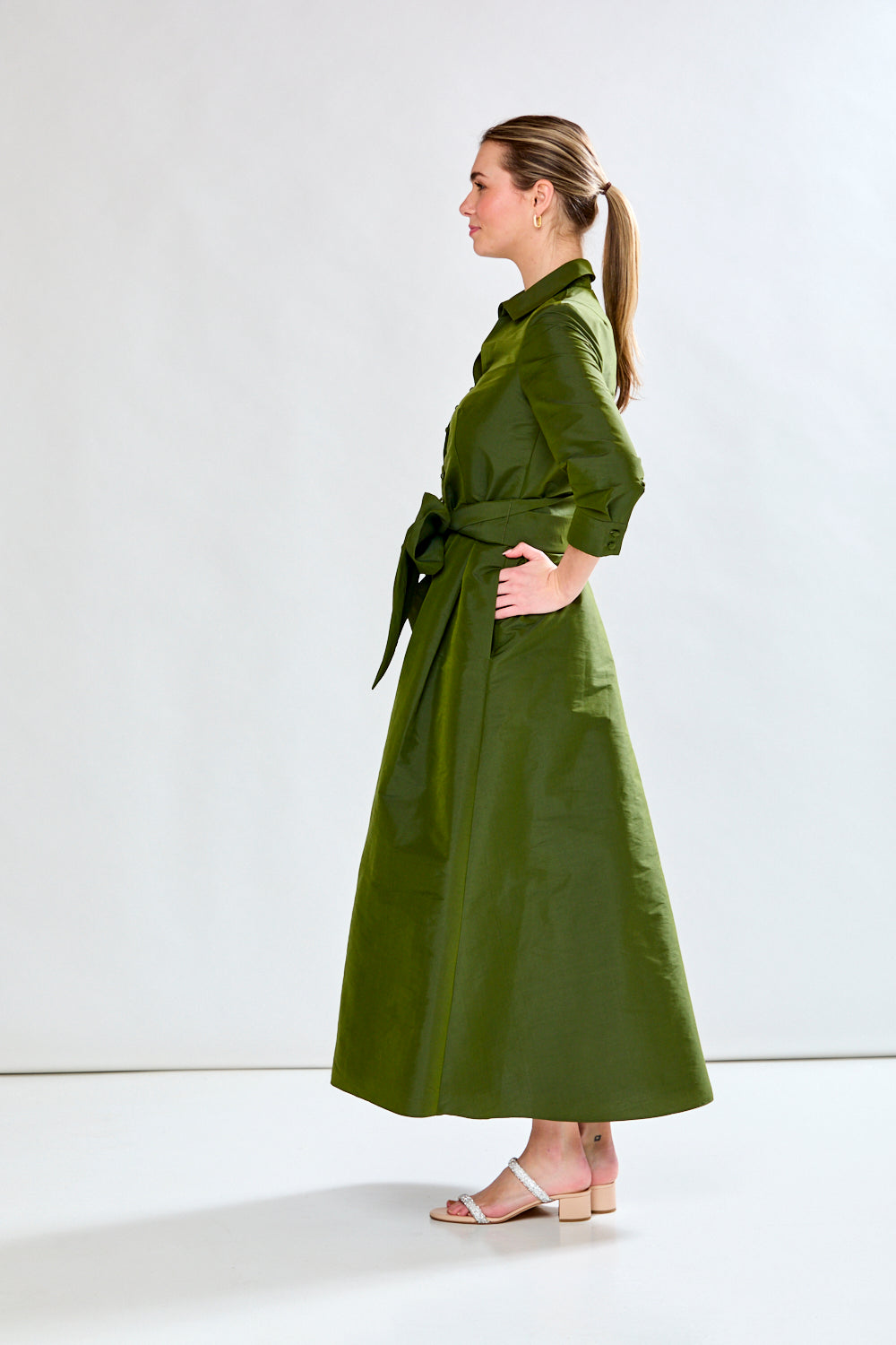 Woman in olive taffeta dress