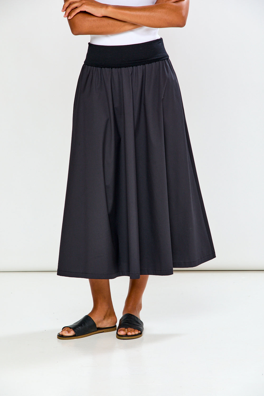 Person wearing a black skirt on a white background