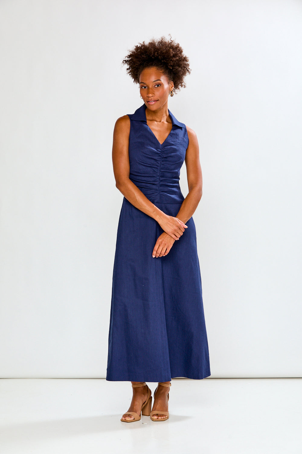 Woman wearing a blue dress against a white background