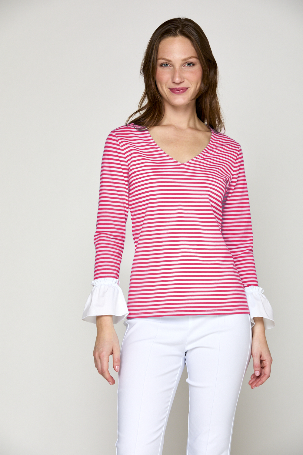 Woman in fuchsia and white stripe top