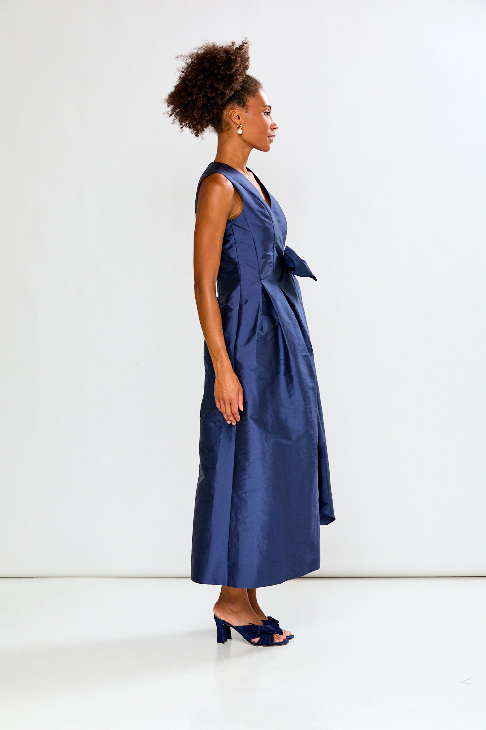 Woman wearing a blue dress against a white background