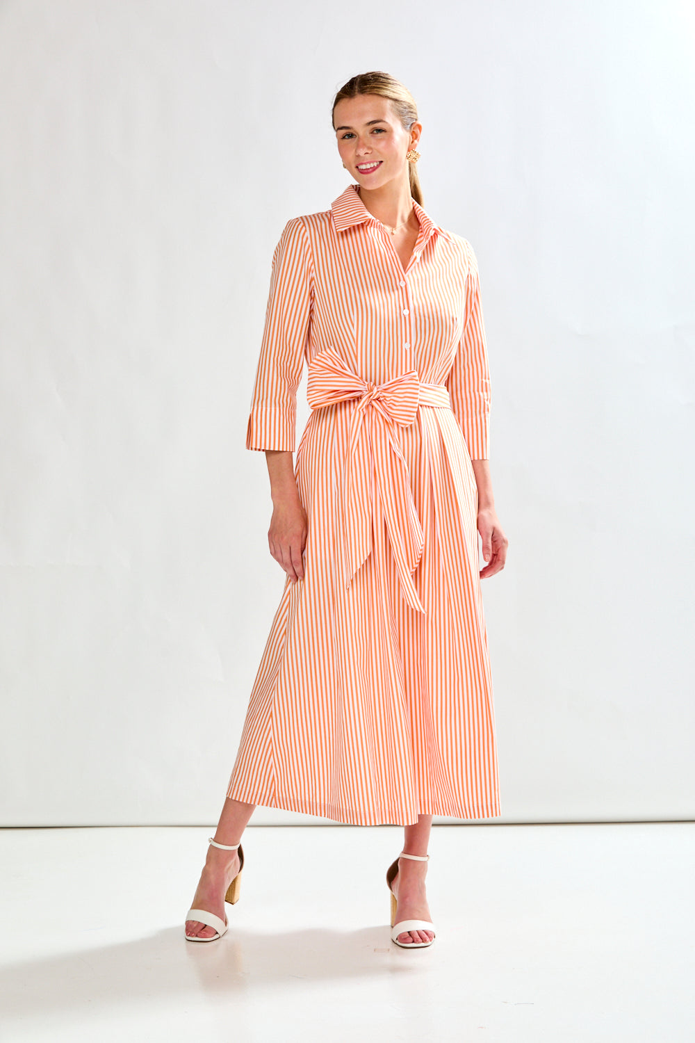 Woman in orange stripe dress