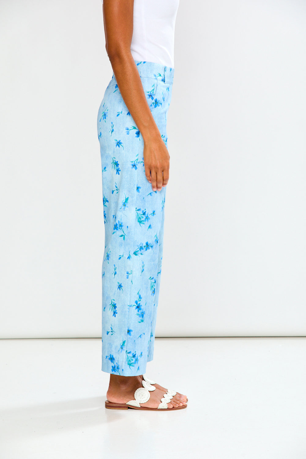 Light blue floral pants worn by a person on a white background