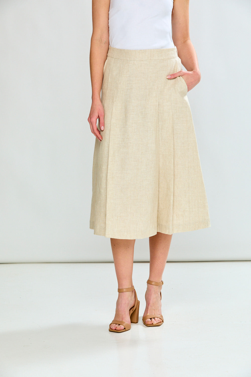 Beige skirt worn by a person on a white background