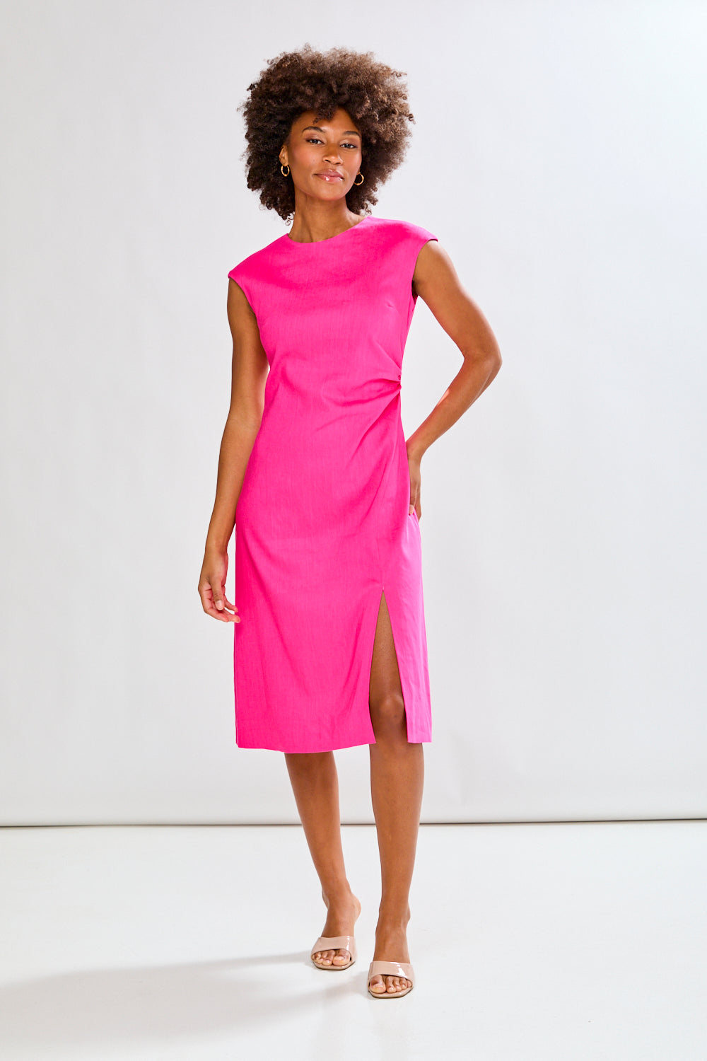 Woman wearing a fuchsia dress on a white background