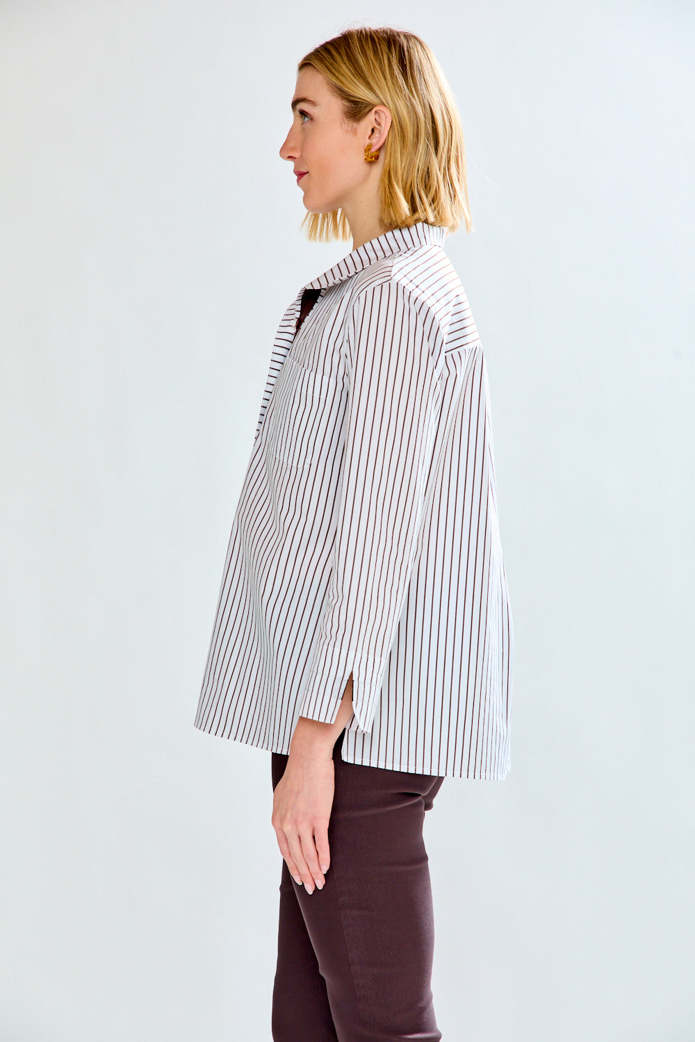 Woman wearing a striped shirt on a white background