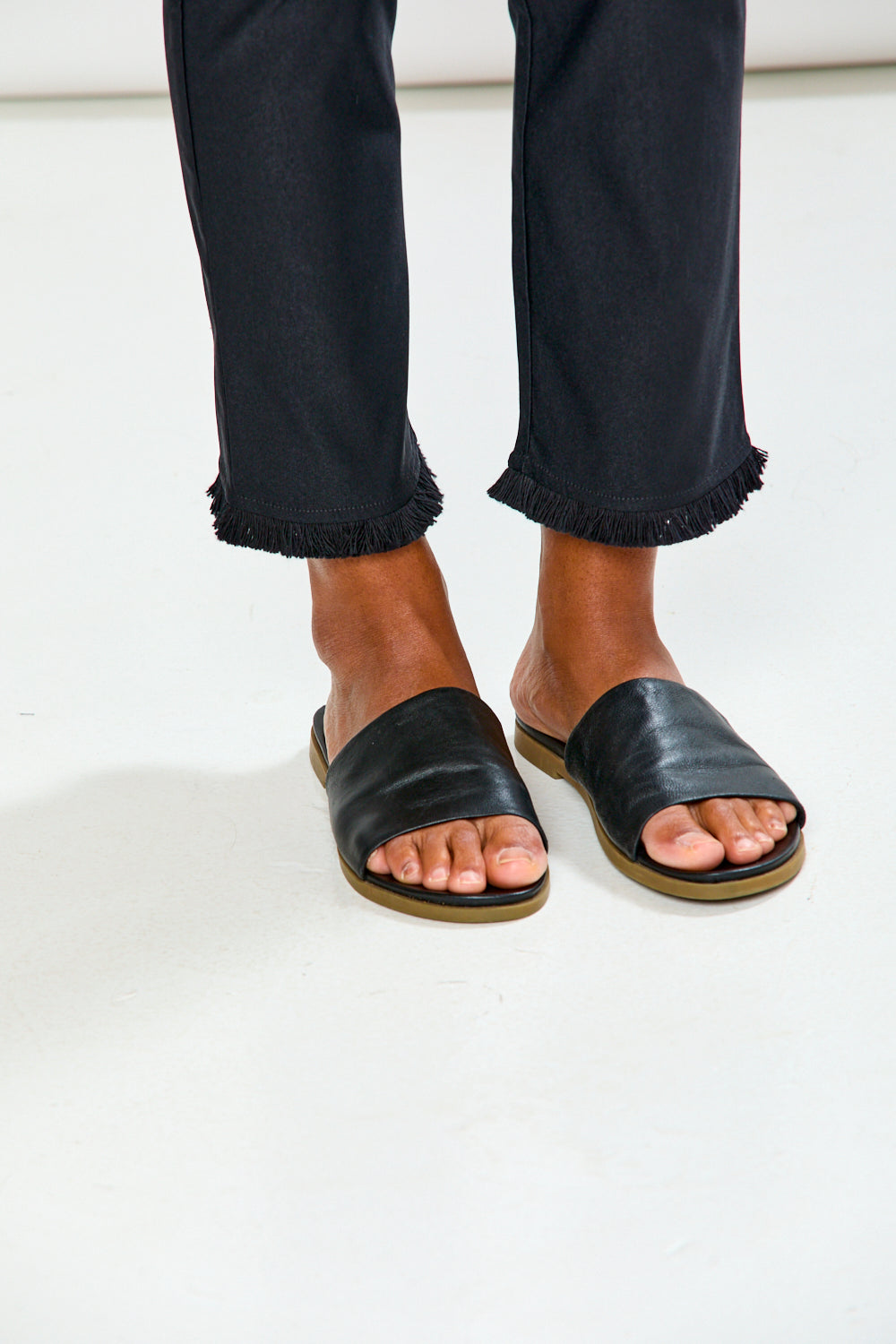Woman wearing black pants on a white background