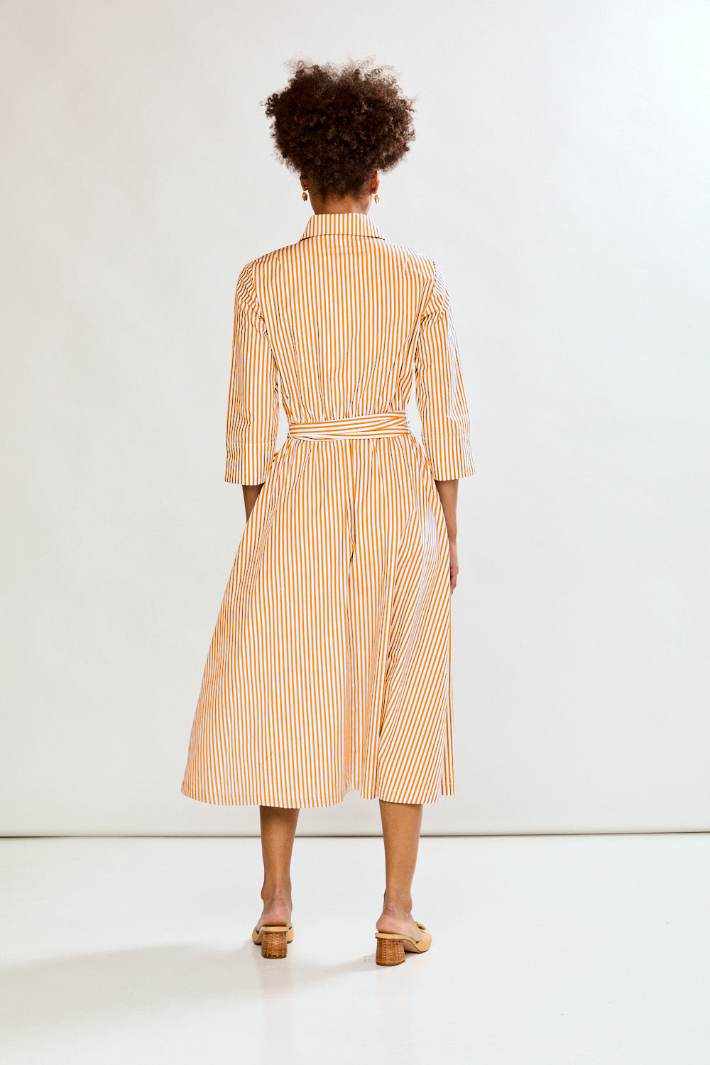 Woman in orange stripe dress