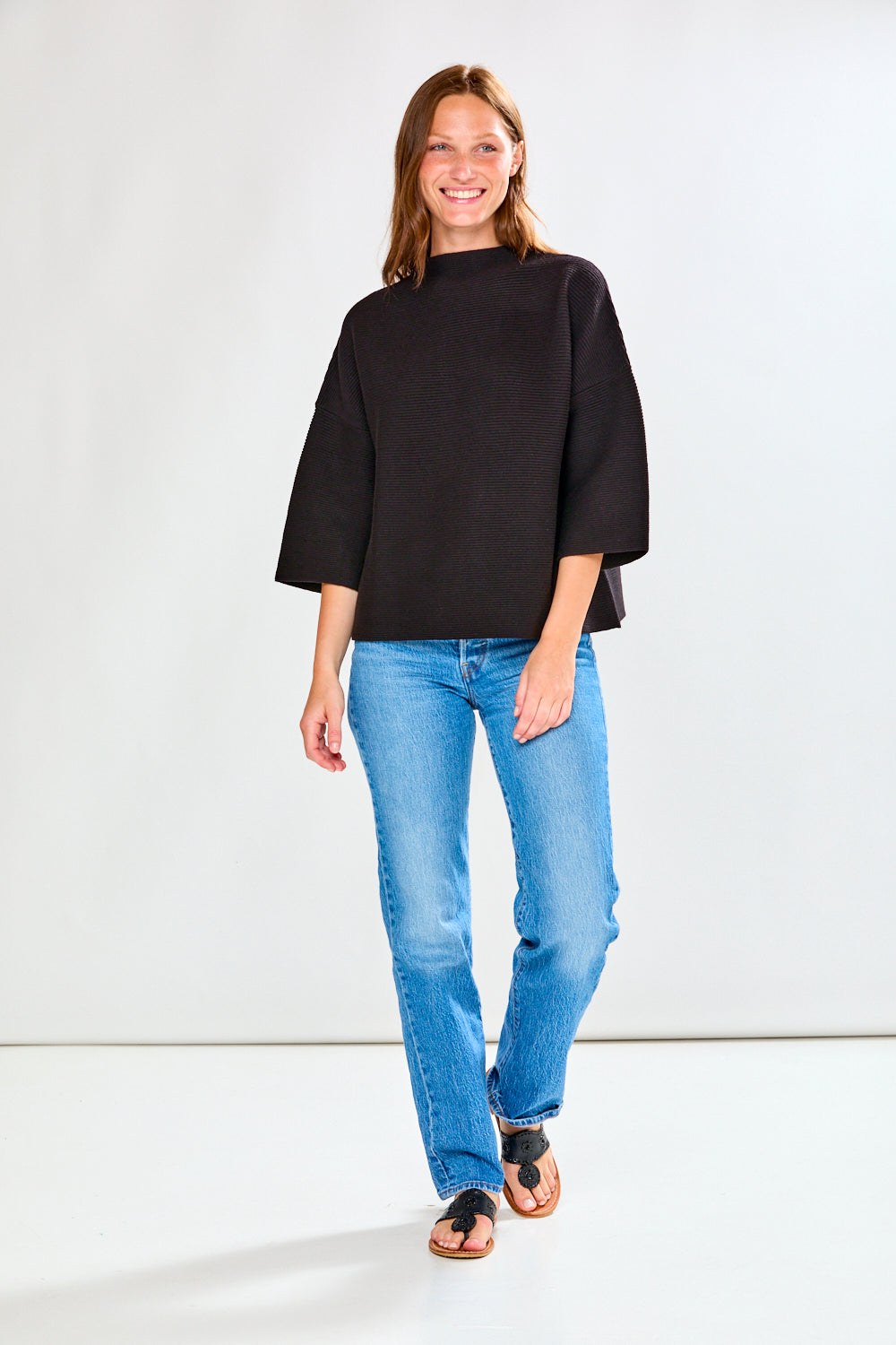 Woman in black ribbed sweater