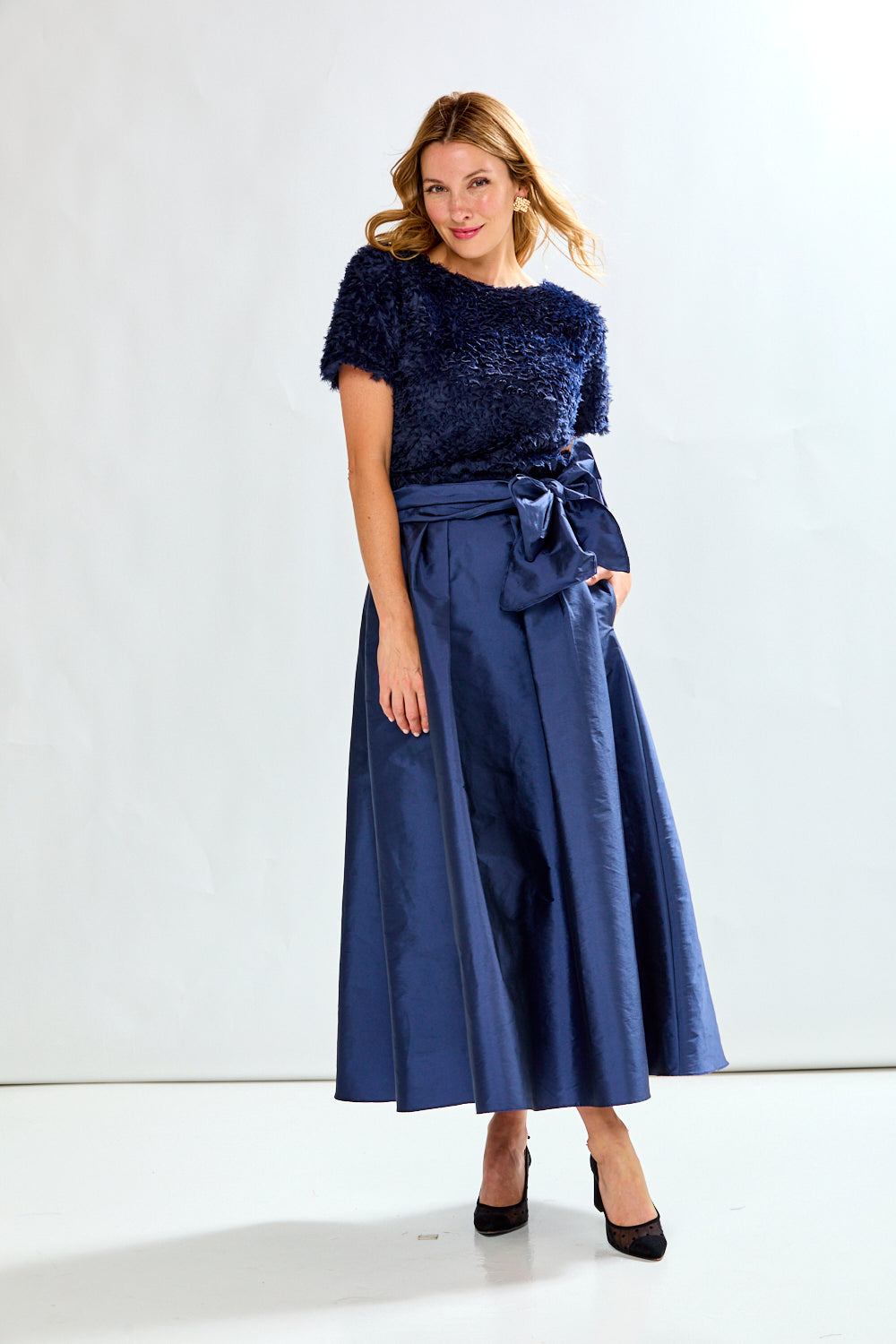 Woman wearing navy taffeta skirt