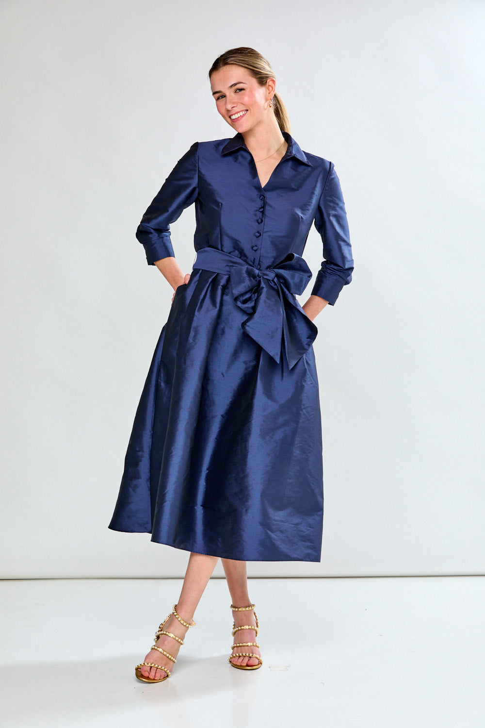 Woman in navy taffeta dress