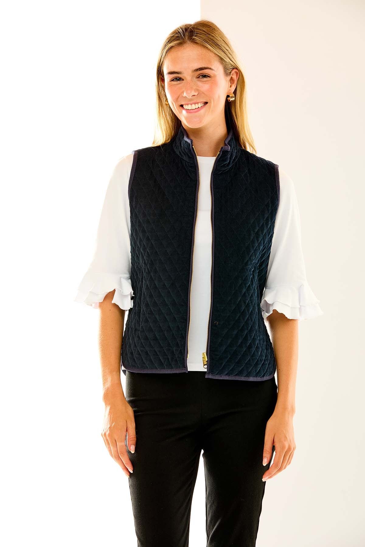 Woman in navy quilted vest