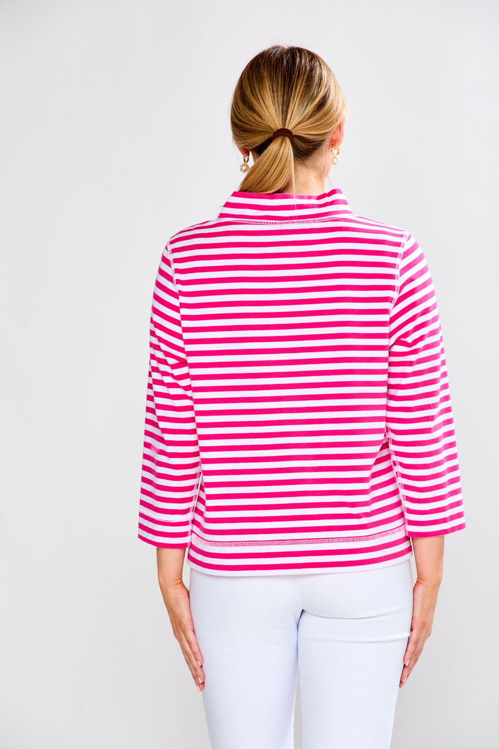 Person wearing a pink and white striped shirt on a plain background