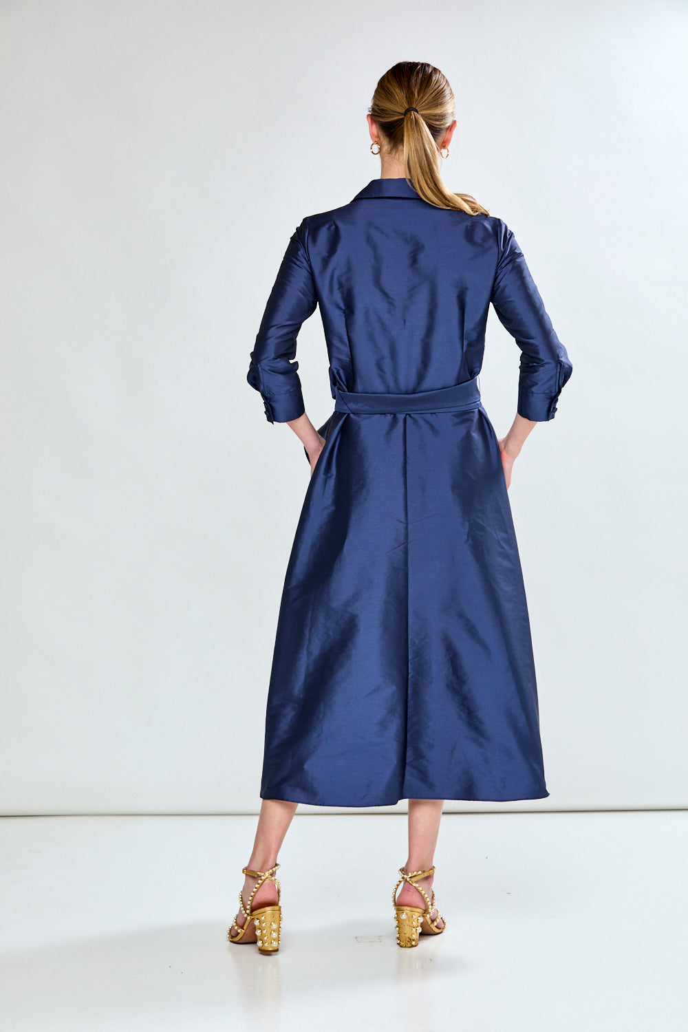 Woman in navy taffeta dress