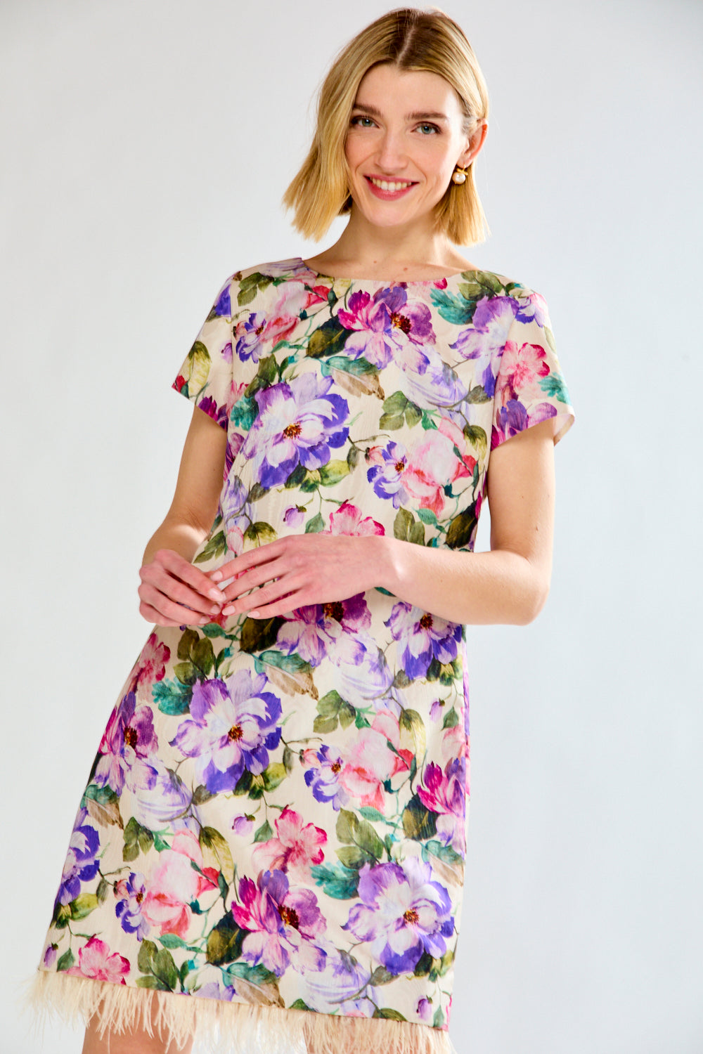 Woman in floral dress with feathers