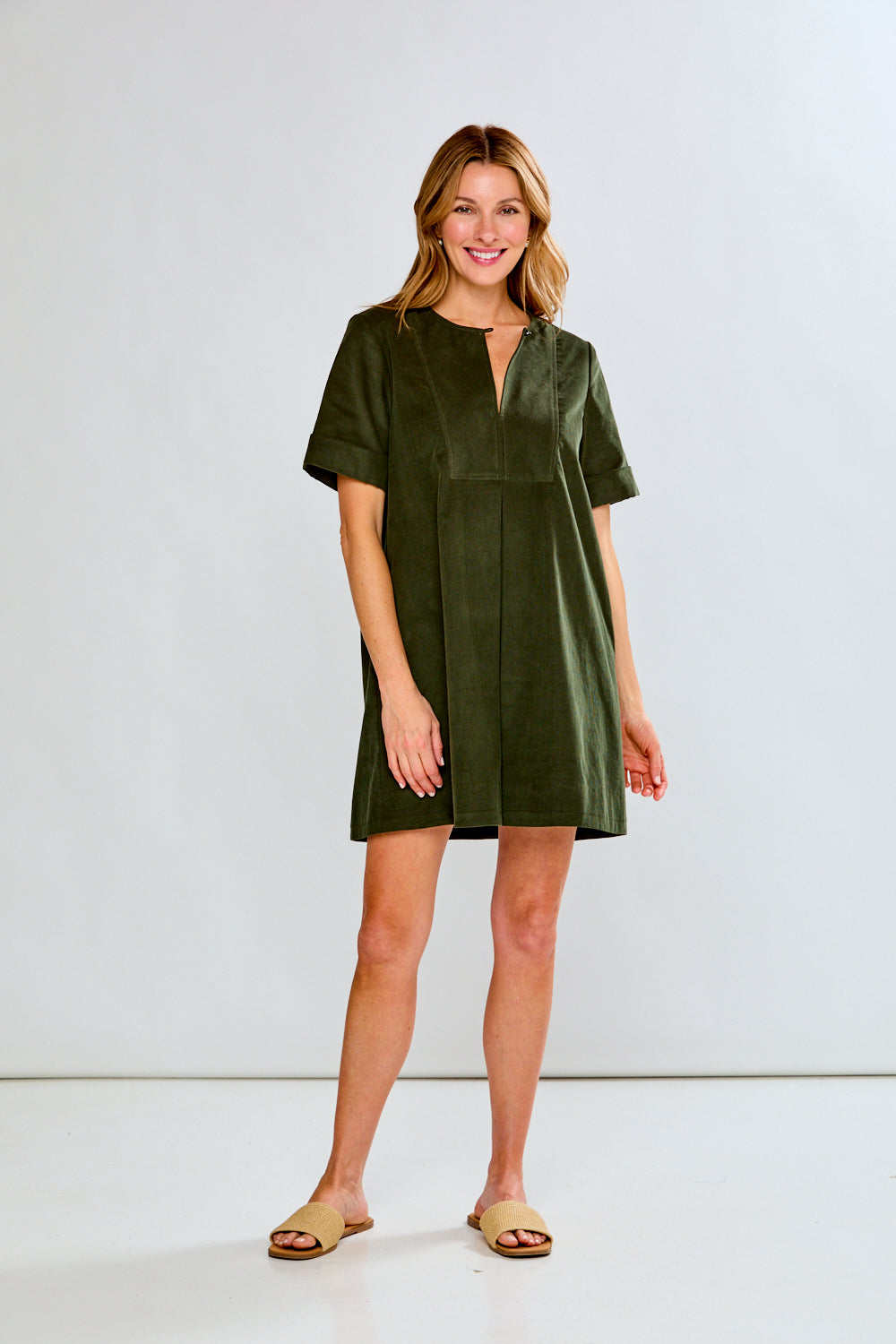 Woman wearing a green dress against a white background