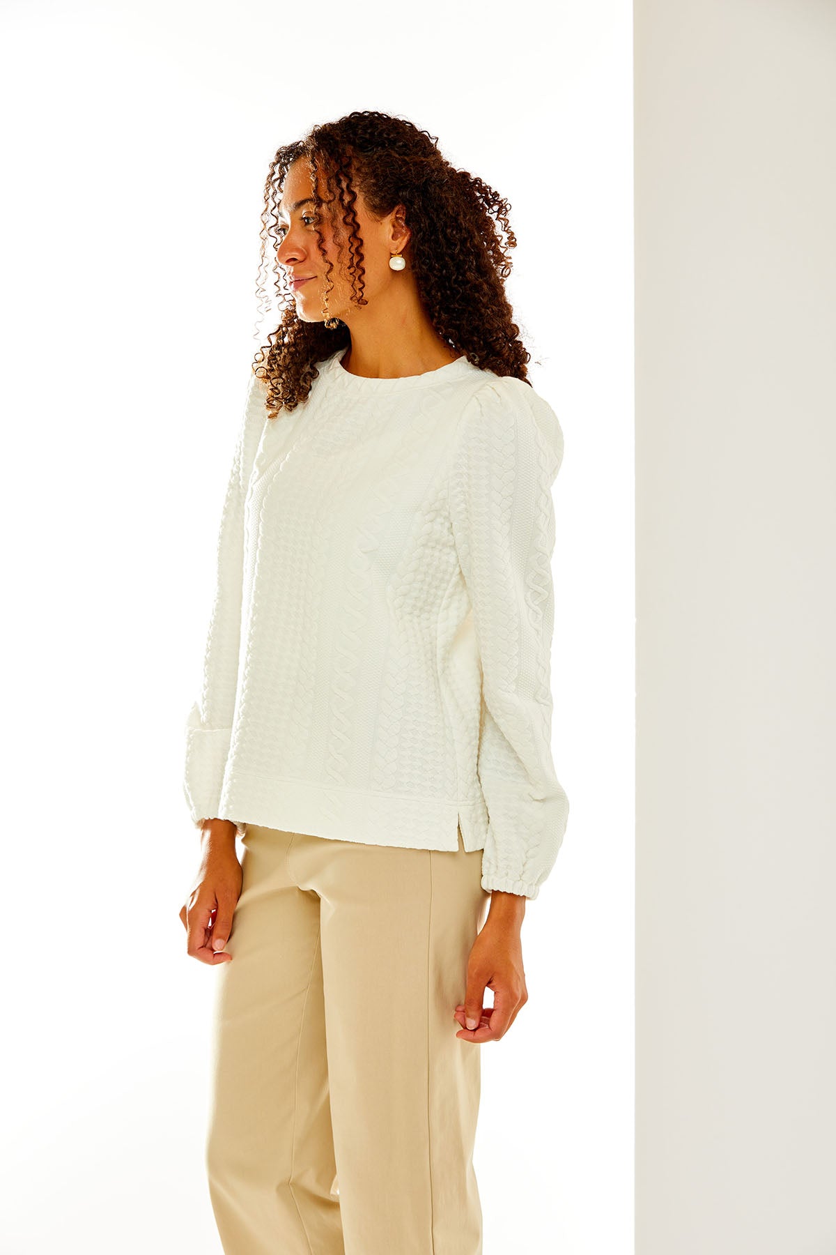 Woman in white cable knit top