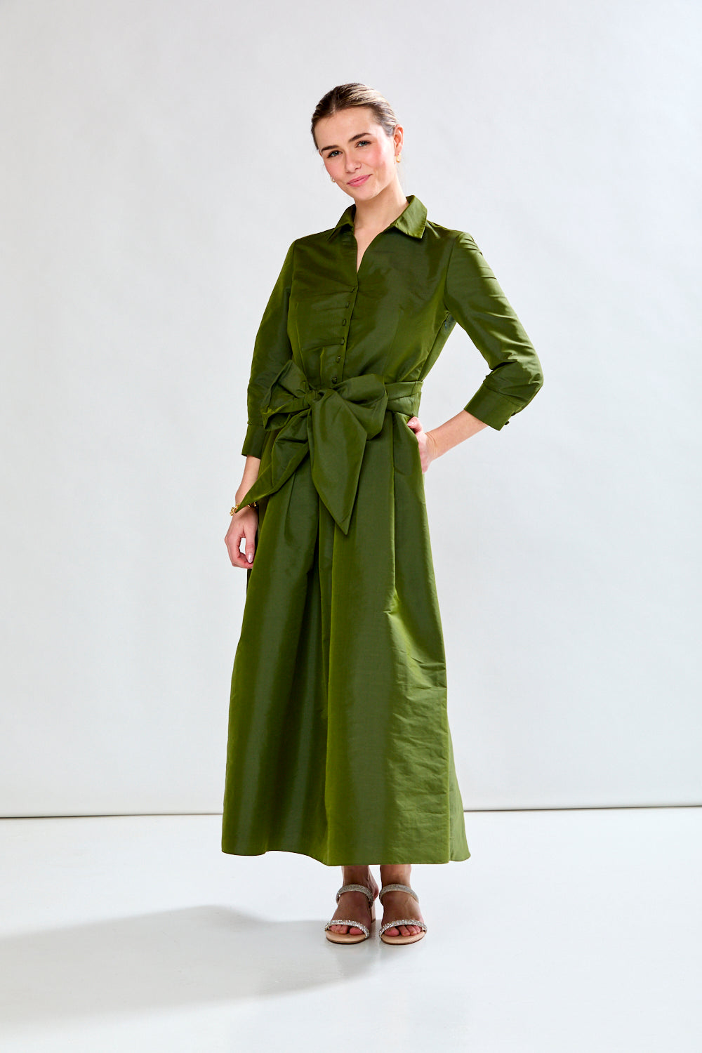 Woman in olive taffeta dress