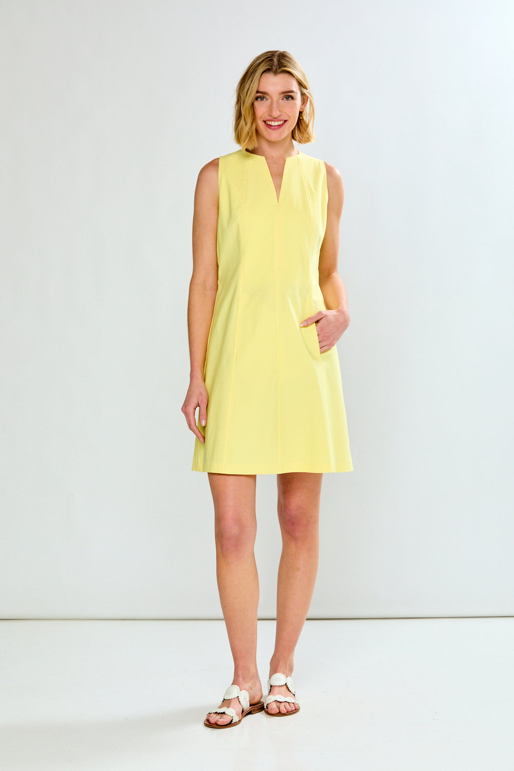 Woman wearing a yellow dress against a white background