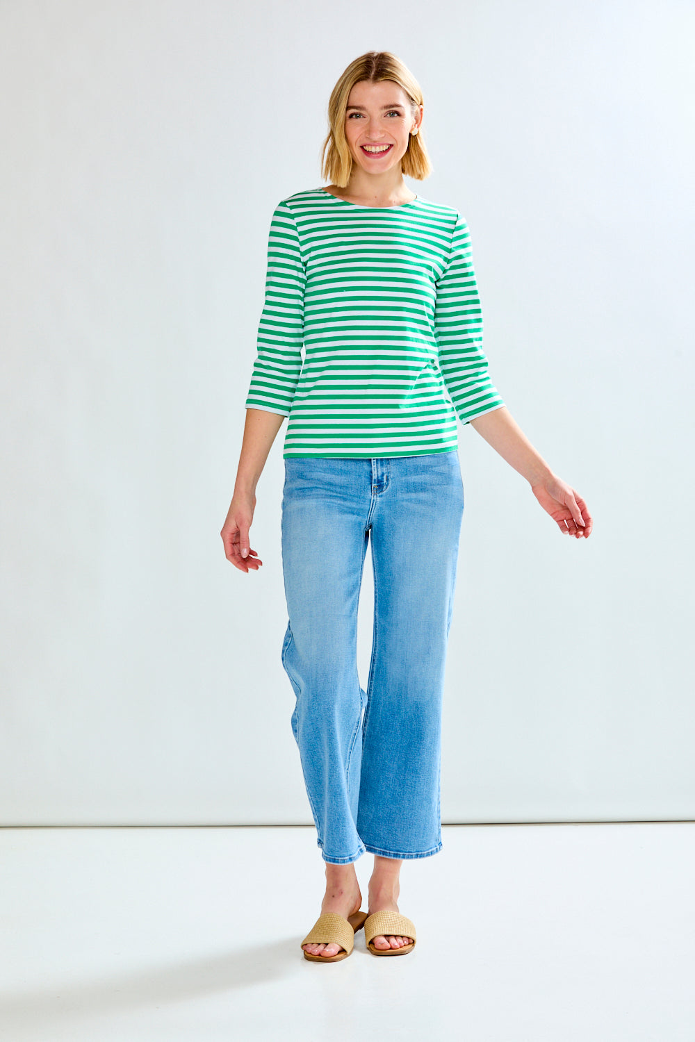 Woman in green/white stripe knit top