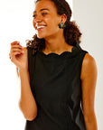 Woman in black scallop dress