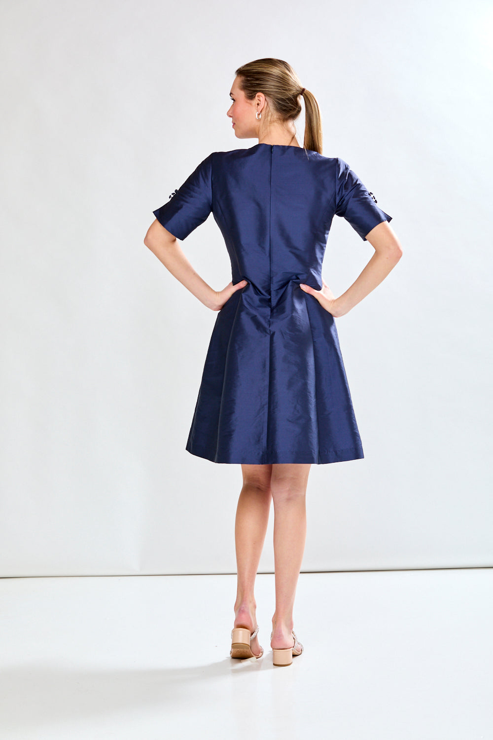 Woman in navy taffeta dress