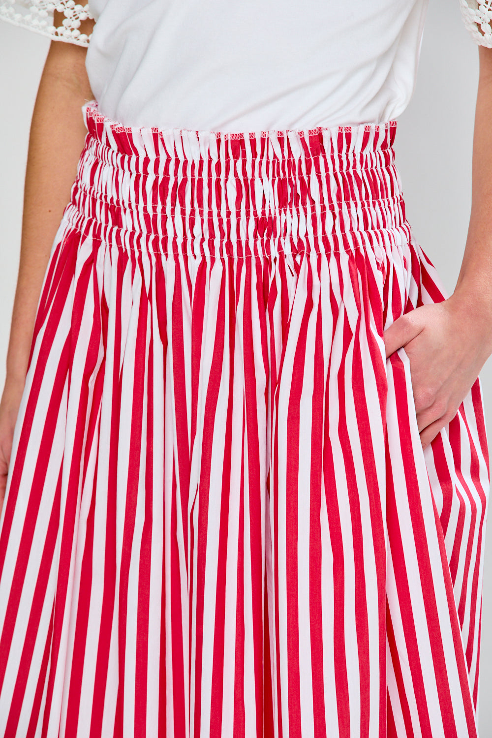 Woman in red & white stripe skirt